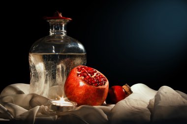 Nar ve bir şişe su kumaş arka plan üzerinde