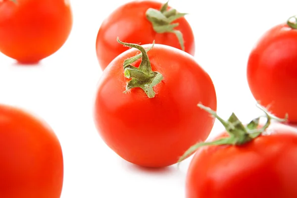 Verse tomaten met groene bladeren geïsoleerd op witte achtergrond — Stockfoto