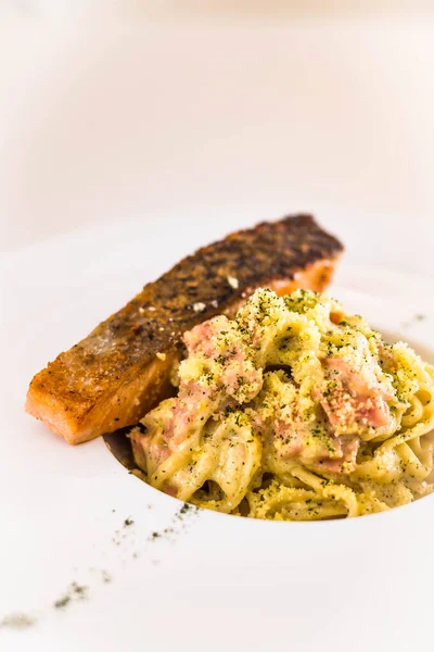 Grilled Salmon Served Spaghetti Carbonara Ham Cream Sauce Grated Cheese — Stock Photo, Image