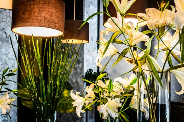 Hanging lights and lilies flower arrangements — Stock Photo, Image