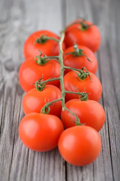 Tomatos on old wood background — Stock Photo, Image