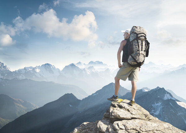 Tourist on peak of high rocks