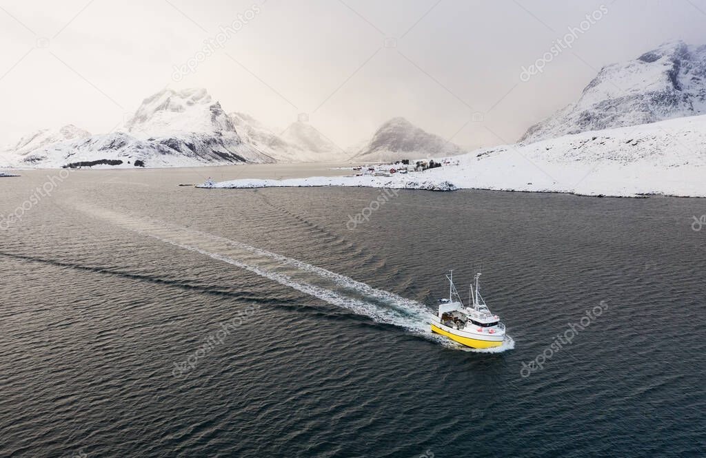 Boats on Lofoten islands, Norway. Mountains and sea. Evening time. Winter landscape near the ocean. Norway travel
