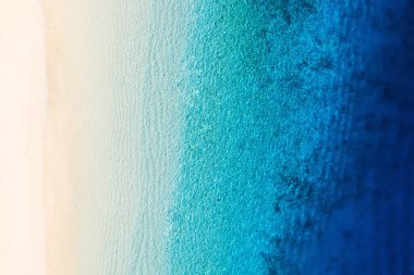 Dalgalar arka plan olarak üstten görünüyor. İHA 'nın gök mavisi arka planı. Havadan gelen yaz deniz manzarası. Gili Meno Adası, Endonezya. Seyahat ve tatil görüntüsü