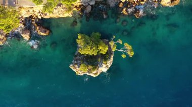Hırvatistan. Kayaların ve ormanın havadan görünüşü. Tatil ve macera. Kayalar ve turkuaz su. Kumsaldaki ve mavi denizdeki İHA 'nın üst görüntüsü. Havadan manzara. Seyahat videosu.