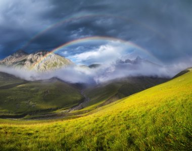 Rainbow in mountain valley