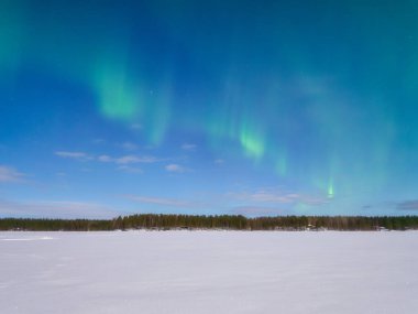 Northern Lights. Aurora Borealis. Landscape at night. Winter wonderland. Scandinavian countries. Vacation and travel in winter north. Photo for background, wallpaper, postcards.