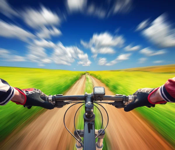 Ride on bicycle on summer field — Stock Photo, Image