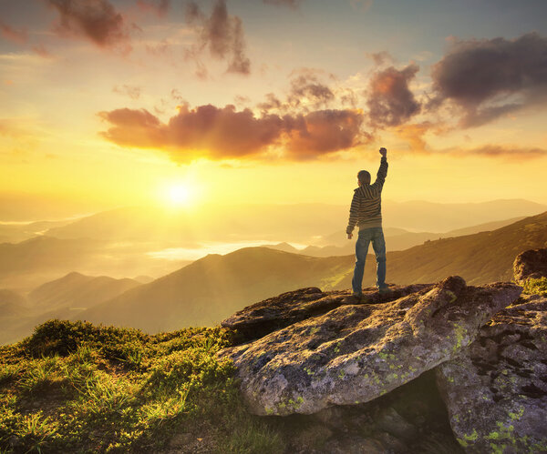 Silhouette of champion on mountain peak