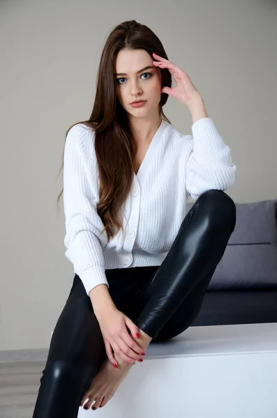 Pretty Young Woman Black Leggings White Sweater Staying Home Polish — 스톡 사진