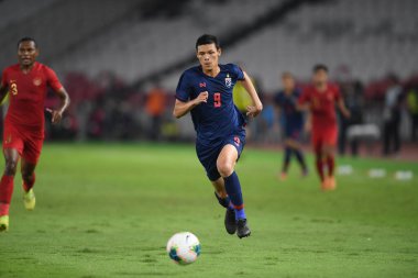 Jakarta Endonezya 10 sep 2019: Supachai, 2020 Dünya Kupası elemeleri sırasında oynanan Dünya Kupası elemeleri sırasında oynanan maçta 9 numaralı Tayland oyuncusunu Gelora Bung Karno Stadyumu 'nda hapse attı