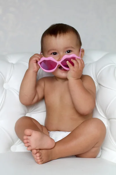 Baby at pink glasses — Stock Photo, Image