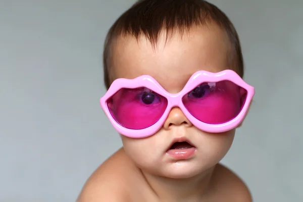 Baby at pink glasses — Stock Photo, Image