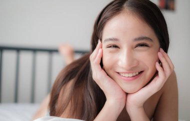 Asian woman with bikini posing in a home environment