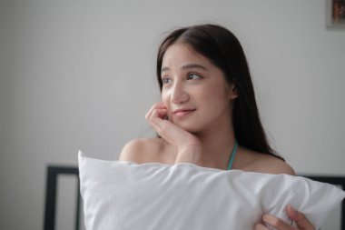 Asian woman with bikini posing in a home environment