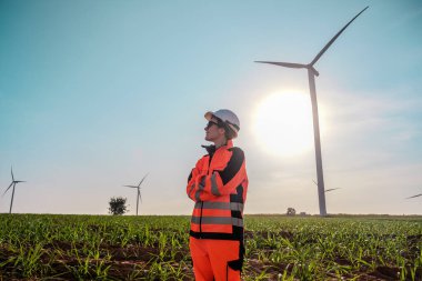 Mühendisler elektrik üretmek için rüzgar türbinlerini inceliyorlar..