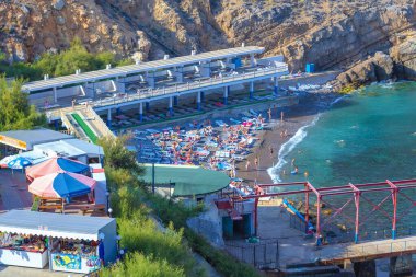 Yalta, Crimea - September 13, 2012: the beach and vacationers in Cape Ai-Todor. View from the observation deck of the castle 