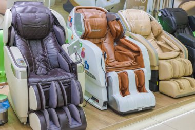 Russia, Omsk - July 05, 2020. Massage leather chairs in the store.
