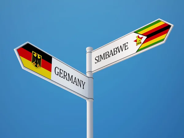 Zimbabwe Tyskland tecken flaggor koncept — Stockfoto