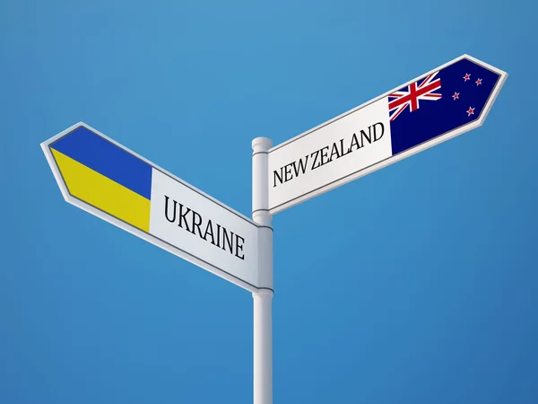 Ukraina nyazeeländskt underteckna flaggor koncept — Stockfoto
