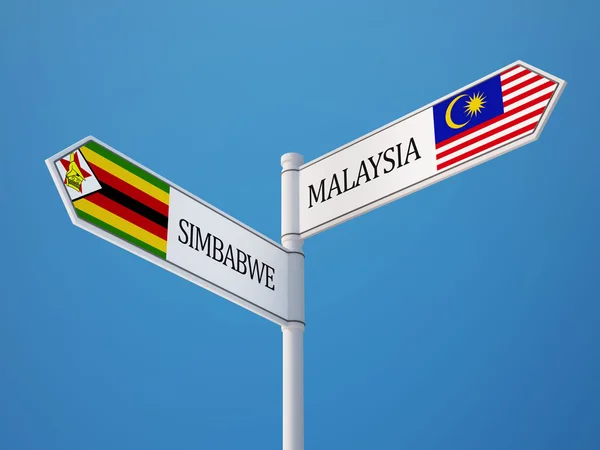 Zimbabwe Malaysia tecken flaggor koncept — Stockfoto