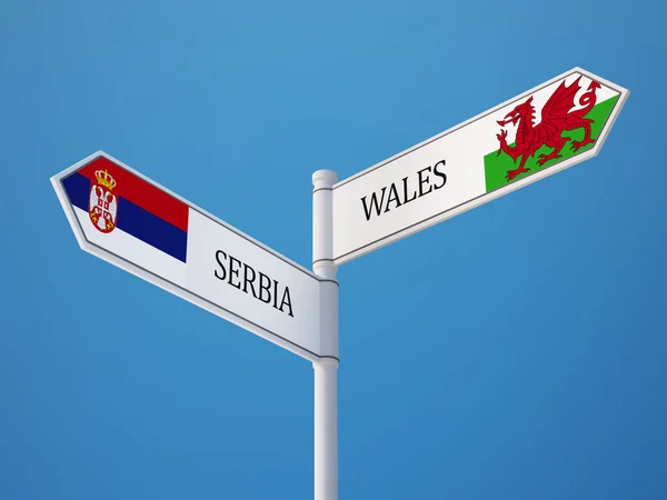 Serbien och Wales tecken flaggor koncept — Stockfoto