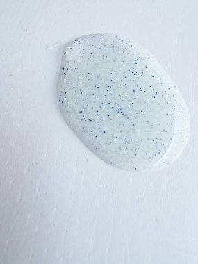 Micro plastic particles in a face scrub on a white background. Representation of the micro plastic problems in personal care products such as exfoliants. clipart