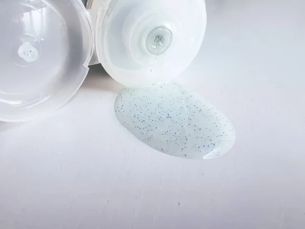 Micro plastic particles in a face scrub on a white background. Representation of the micro plastic problems in personal care products such as exfoliants.