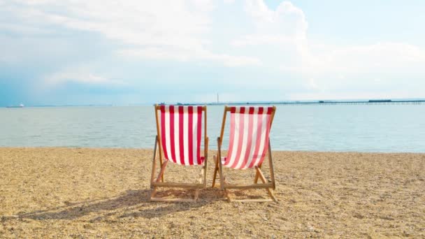 Two deckchairs on a beach — Stock Video