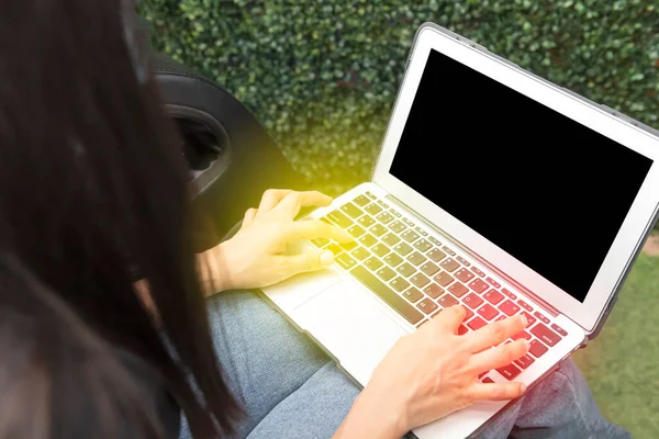 Young woman with a computer with a blank black screen with copy space and creative ideas and designs