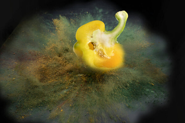 Sliced bell pepper fall color powder explosion of colored powder with space for abstract background.