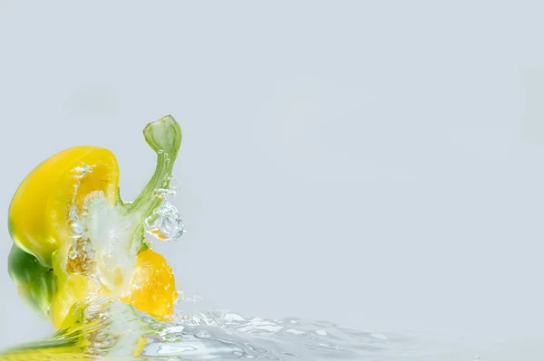 Gele Paprika Stukken Gesneden Spat Het Water Voedselingrediëntenconcept — Stockfoto