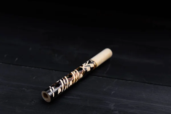 Musical instrument flute, on wooden background