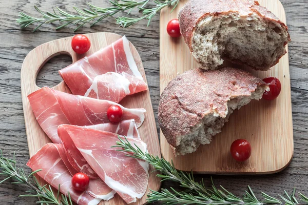 Slices of jamon on the wooden board — Stock Photo, Image