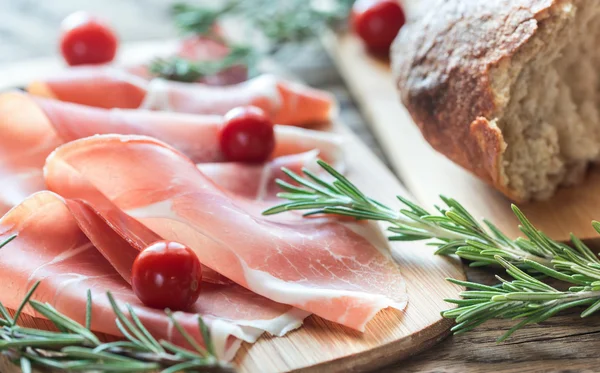 Slices of jamon on the wooden board — Stock Photo, Image