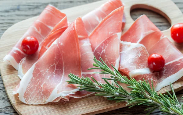 Slices of jamon on the wooden board — Stock Photo, Image