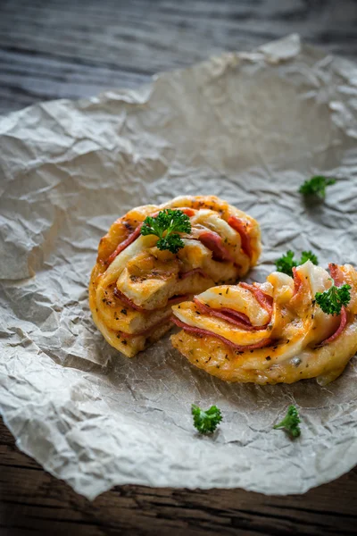 Pizza rolls on the wooden board — Stock Photo, Image