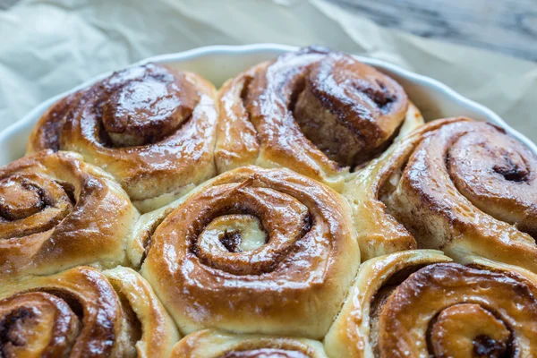 Cinnamon rolls on the wood background — Stok Foto