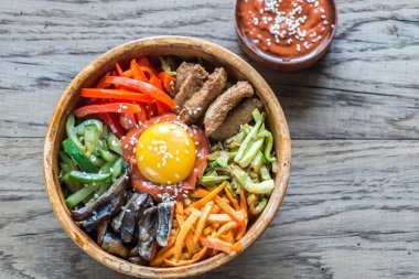Ahşap masa üzerinde bibimbap kase