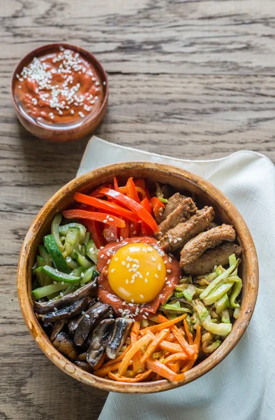 Bowl of bibimbap on the wooden table — Stock Photo, Image