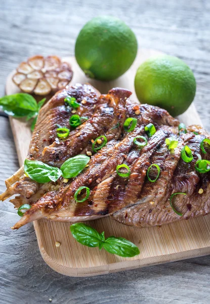 Grilled turkey with green scallion on the wooden board — Stock Photo, Image