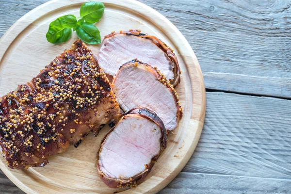 Baked pork meat wrapped in bacon — Stock Photo, Image