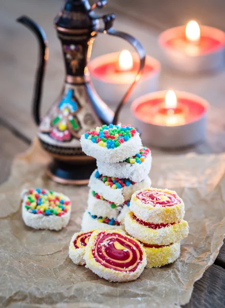 Heap of Turkish delight with burning candles — Stock Photo, Image