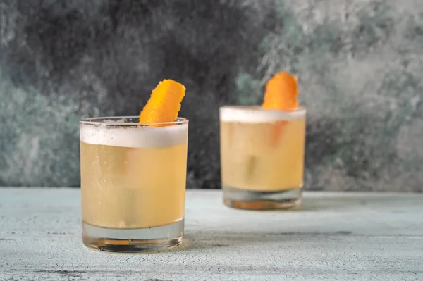 Two glasses of whiskey sour cocktail close up