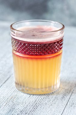 Glass of New York Sour garnished with cocktail cherry and lemon peel clipart