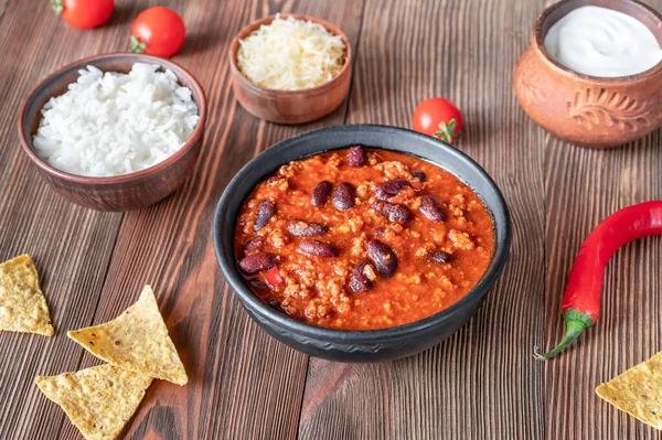 Bowl of chili con carne with ingredients