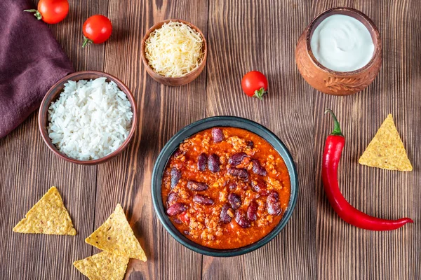 Bowl of chili con carne with ingredients