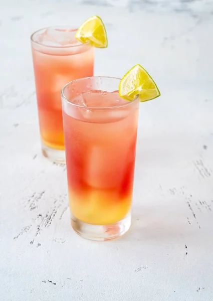 Two Glasses Bay Breeze Cocktail Garnished Lime Wedges Wooden Background — Stock Photo, Image