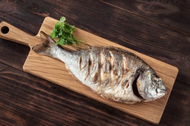 Tahtada ızgara dorada balığı var.