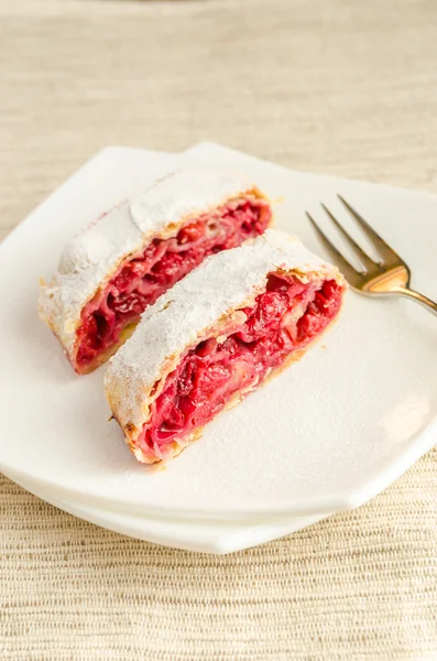 Cherry strudel on the square plate — Stock Photo, Image